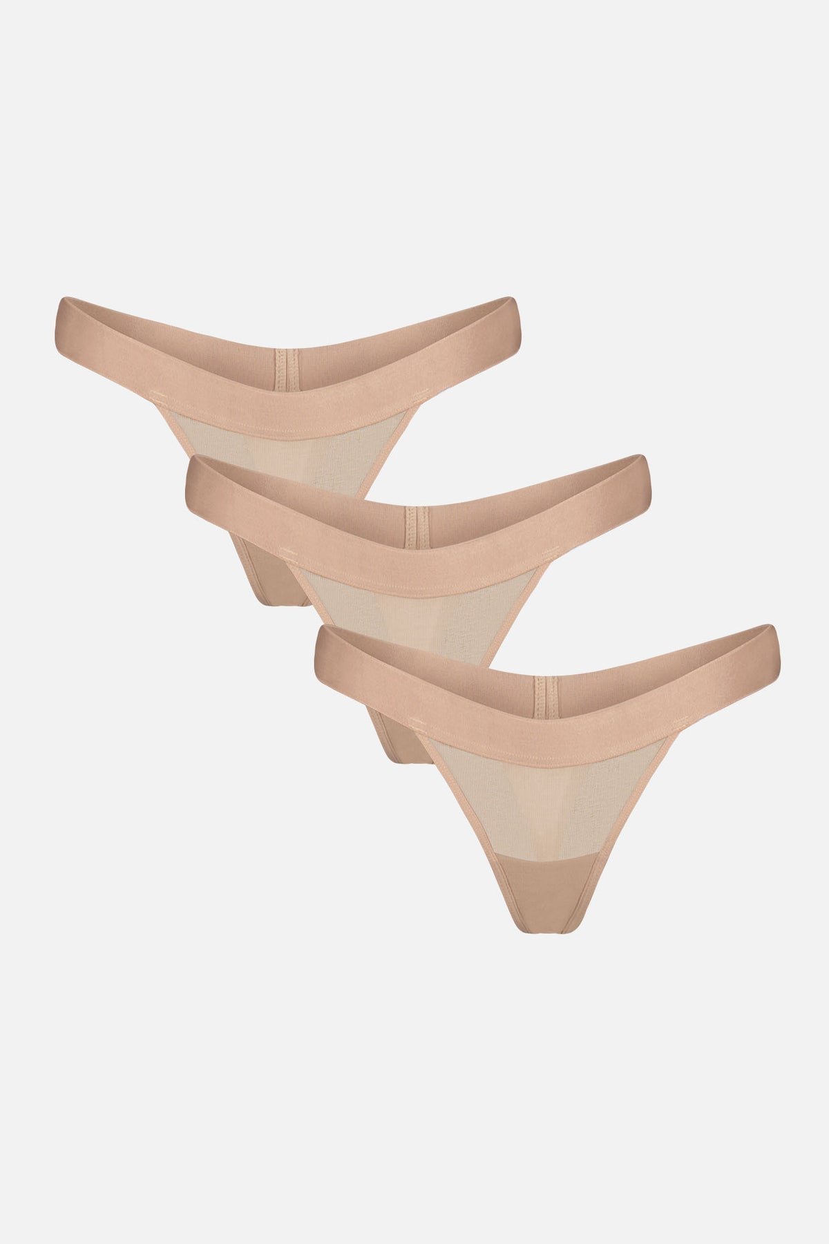 Three pairs of sheer nude mesh thong panties with solid beige elastic waistbands, arranged diagonally on a light gray background.