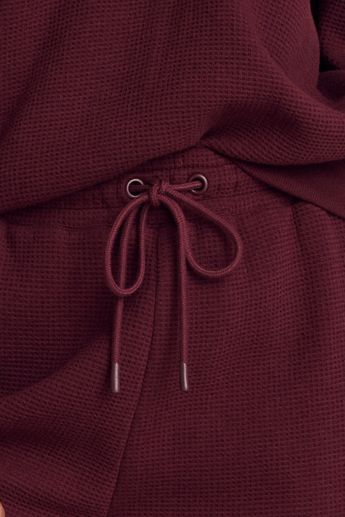Garnet waffle knit cropped track pant, detail view of cropped hem and drawstring