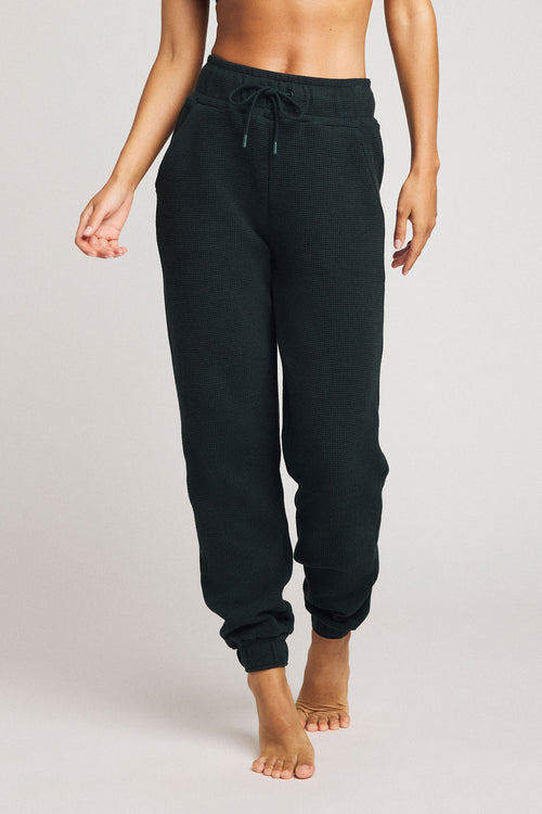 Dark cypress waffle-knit jogger pants with front drawstring and cuffed ankles