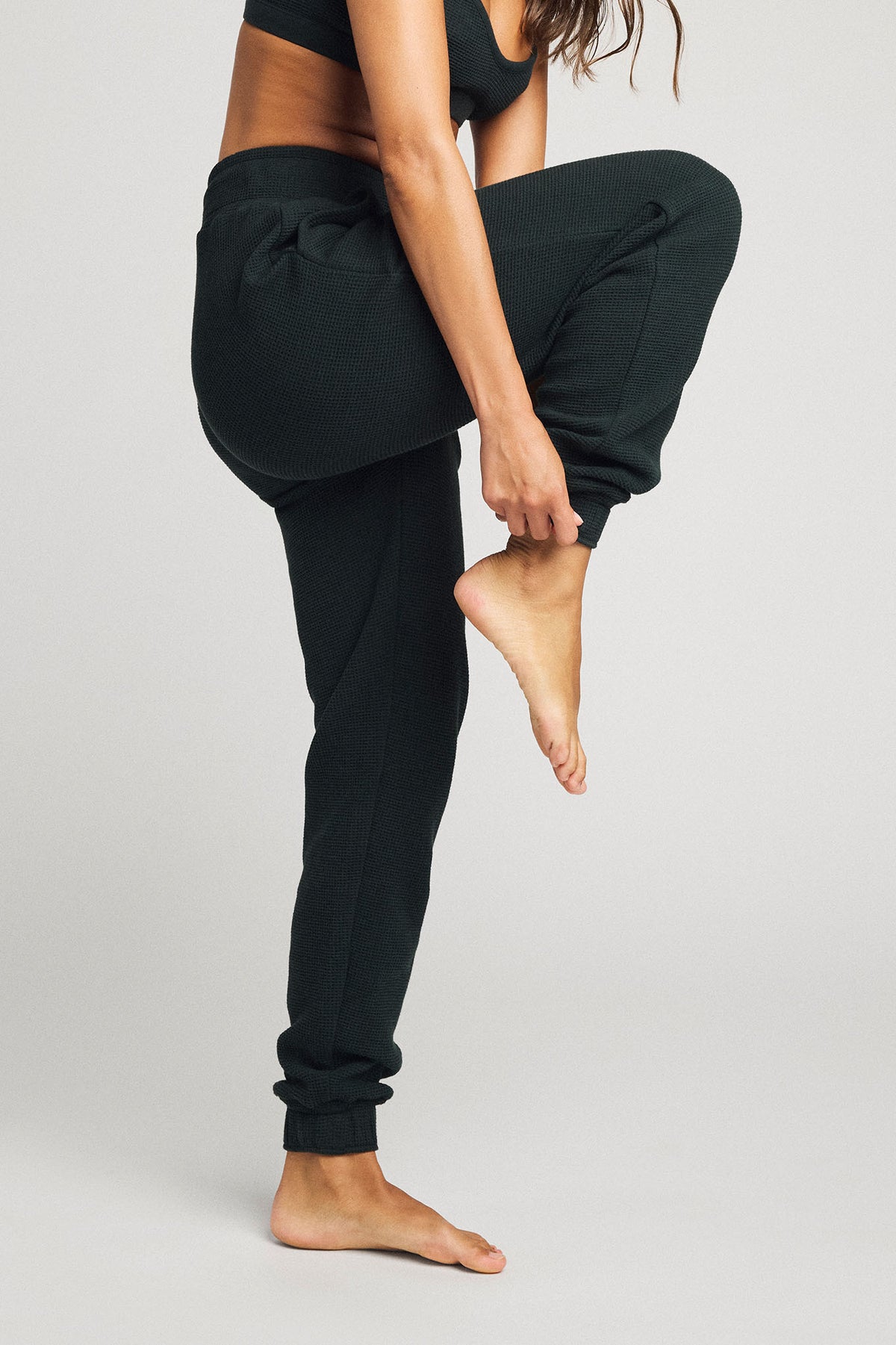Dark cypress jogger pants with gathered ankle cuffs and side pocket