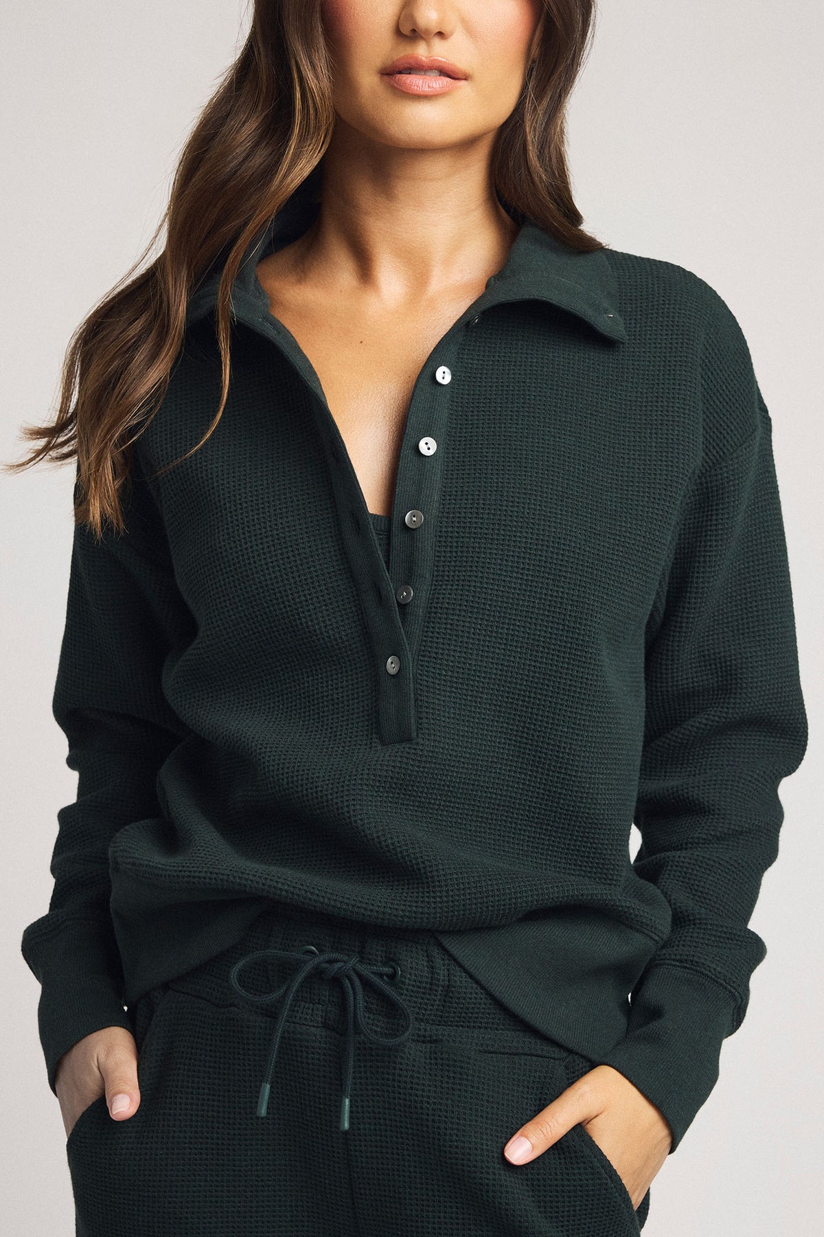 Dark teal waffle-knit pullover with henley collar and button placket, long sleeves