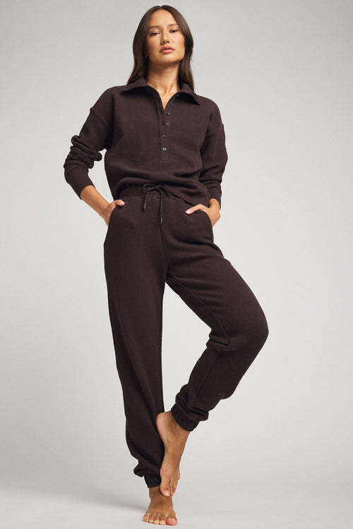 Dark brown waffle-knit jogger pants with drawstring waist and ankle cuffs, full length