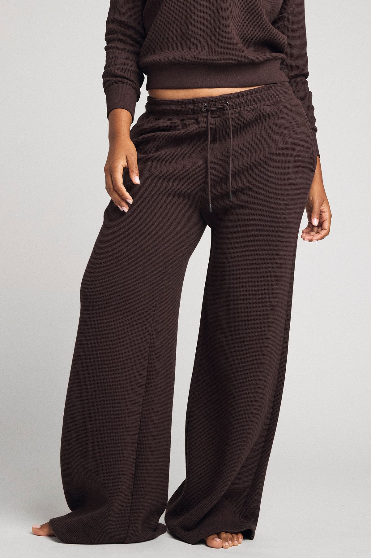 Women's waffle knit track pants in dark brown with drawstring waist and wide legs