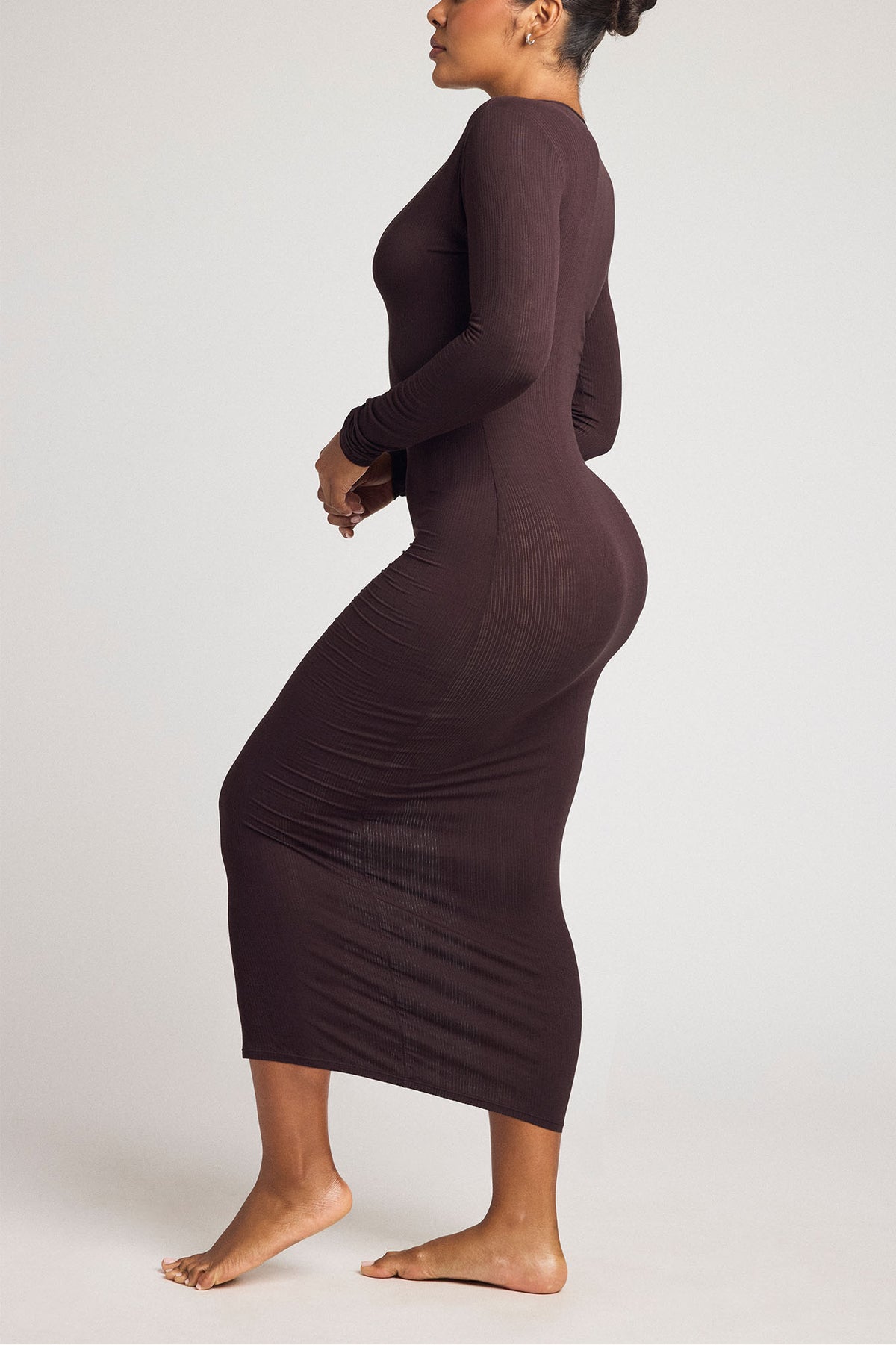 Dark brown fitted henley midi dress with long sleeves and curved side seam detail.