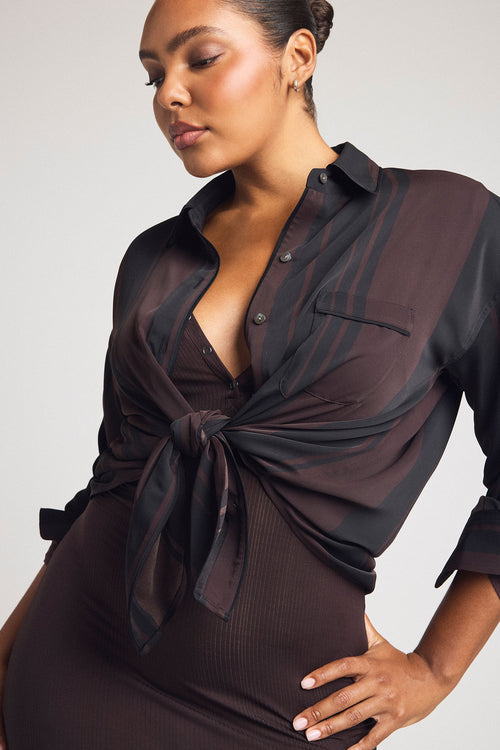 Dark brown henley midi dress with deep V; draped tie-front overlay at chest.