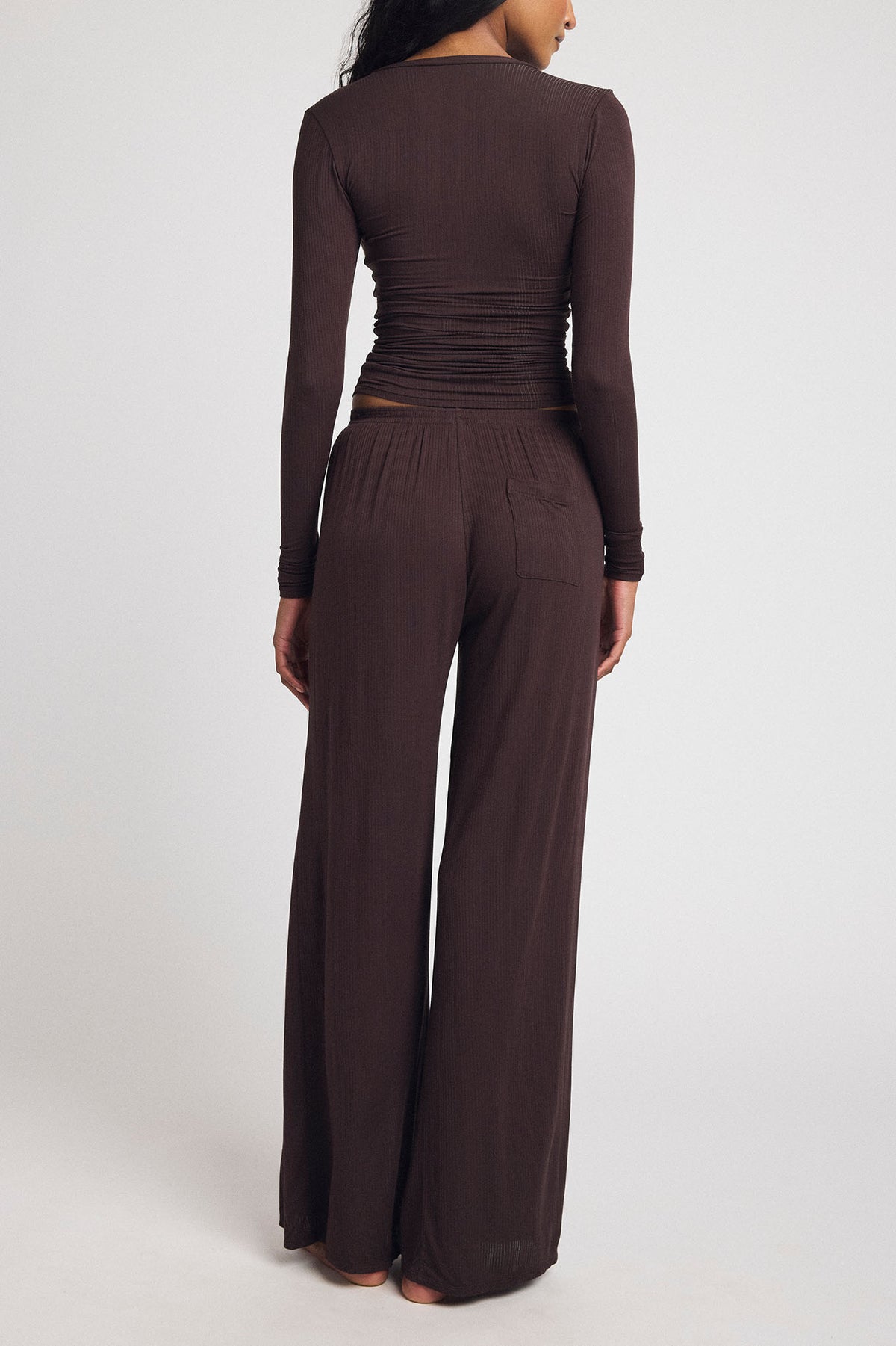 Dark brown wide-leg track pants with elastic waist and long back seam