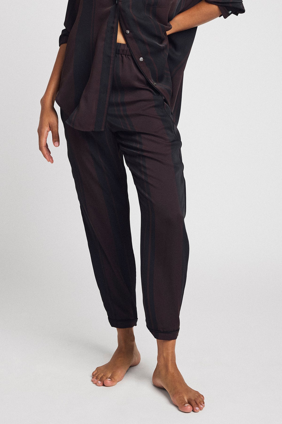 Dark brown striped jogger pants with elastic cuffs and drawstring waist