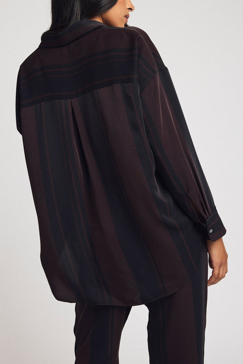 Back view of women’s ganache stripe button-up shirt with long sleeves and curved hem